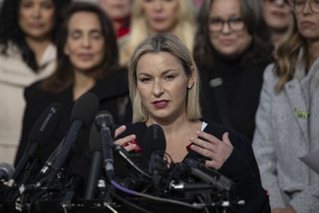a woman speaks into microphones