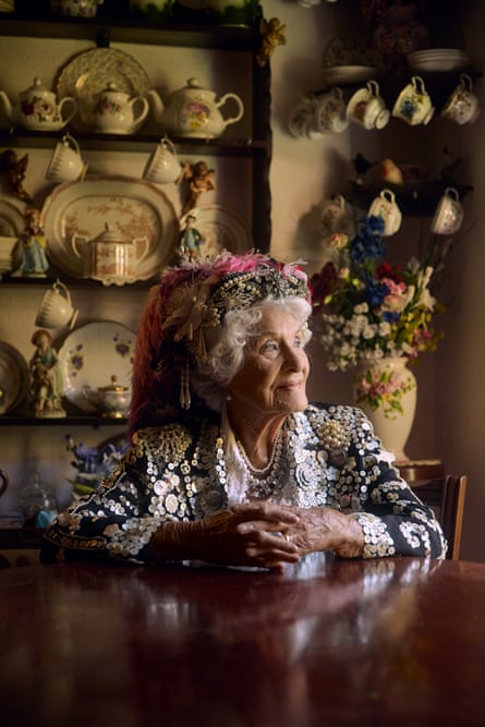 Phyllis Broadbent sat at a table in her kitchen in full pearly outfit