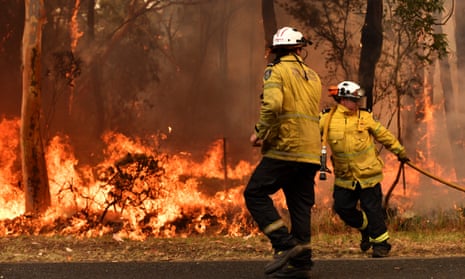 NSW Rural Fire Service firefighters battle a blaze on the central coast. Many of the sleep-deprived volunteer crew are taking leave without pay and are stretched beyond endurance by the weeks-long bushfires. 