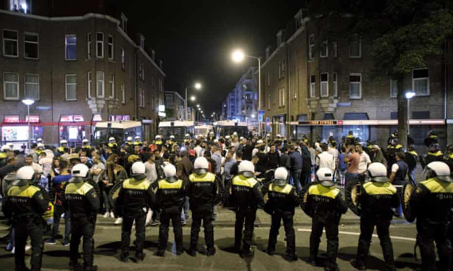 Dutch riot police clash with protesters in Schilderswijk, The Hague.