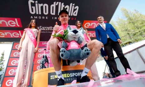 Chris Froome celebrates as he wears the pink jersey on the podium after winning stage 19.