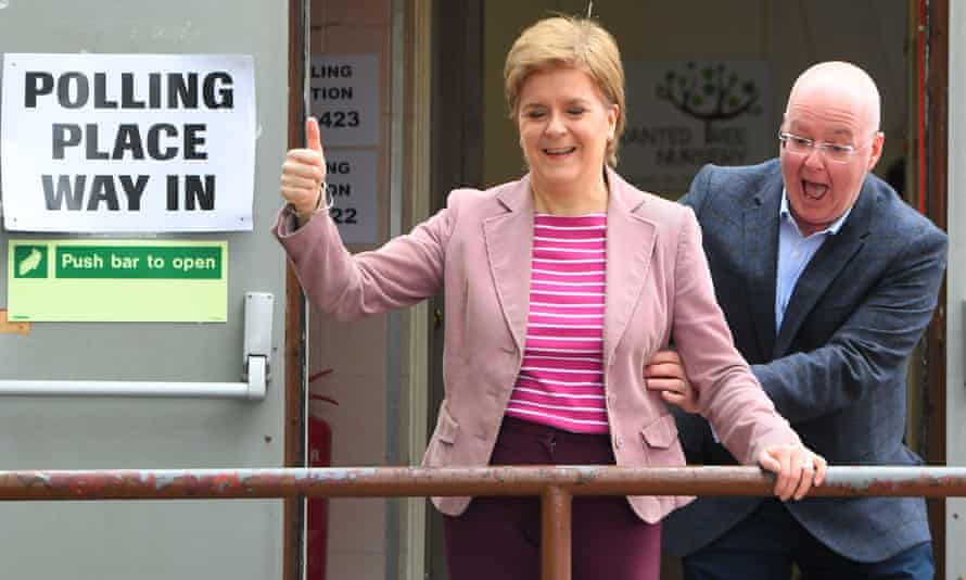 Scotland’s first minister and Scottish National Party (SNP) leader Nicola Sturgeon reacts as she is surprised by her husband and current SNP chief executive officer Peter Murrell, after casting their vote in local elections in Glasgow.