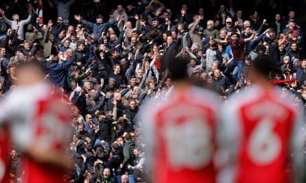Arsenal fans celebrate a goal.