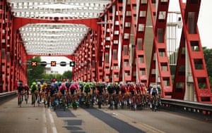 The peloton crosses a bridge.