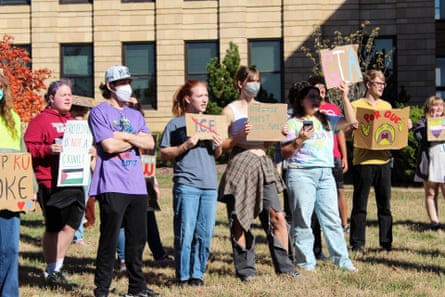a group of people protesting and holding signs