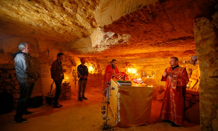 Orthodox priests and local believers pray at underground chapel in Odesa catacombs. They pray for the health of their relatives and the victory of Ukraine. EPA/STR.