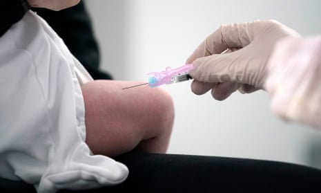 Baby receiving vaccine injection in leg