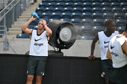 Marc Guiu and Trevoh Chalobah hang out by the big fan while dousing themselves with water.