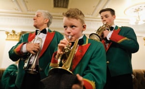 A young band member warms up as he waits to be called forward to perform