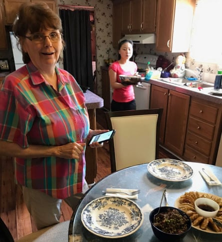 A woman and her daughter serving Chinese dumplings in a kitchen