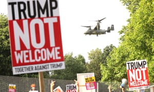 Protesters in Regent’s Park, London, as a US military helicopter flies overhead.