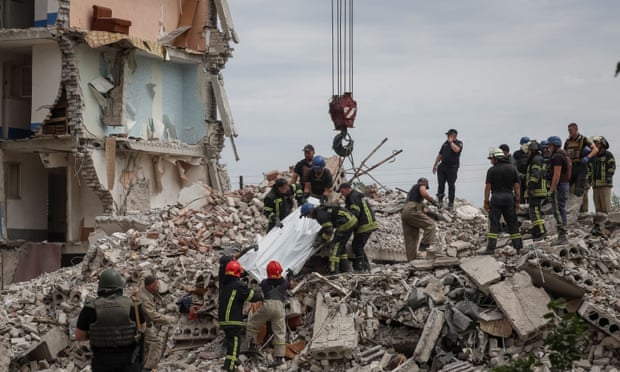 Rescuers extract a body from a residential building damaged in a Russian military strike in the town of Chasiv Yar, in Ukraine’s Donetsk region