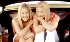 two young blonde women sitting in back of car