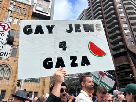 A man holds up a sign that says ‘Gay Jews 4 Gaza’
