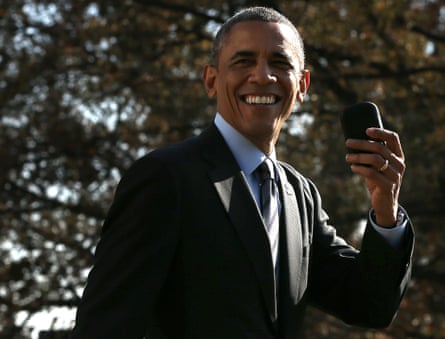 Former President Barack Obama holds up his BlackBerry in 2014.
