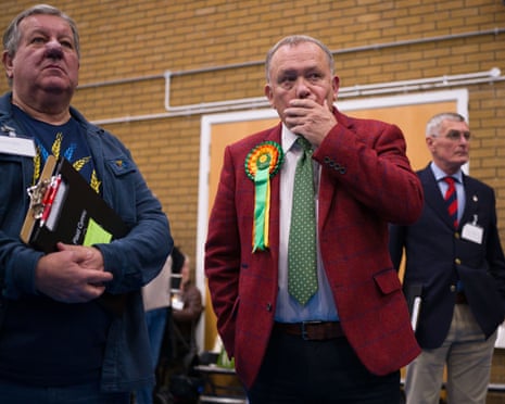 Plaid Cymru candidate Lindsay Whittle, centre, looking on during the count at the Caerphilly leisure centre