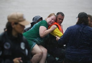 A woman is brought to safety in Lismore