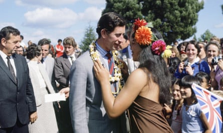 A young Prince Charles kisses a Polynesian woman during a walkabout in New Zealand.