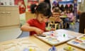 A girl playing with a jigsaw at the Sure Start Palfrey Nursery in Walsall, West Midlands.<br>H0B3H2 A girl playing with a jigsaw at the Sure Start Palfrey Nursery in Walsall, West Midlands.