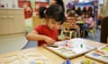 A girl plays with a jigsaw at a Sure Start nursery.