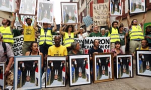 Protesters holding official portraits of French President Emmanuel Macron allegedly taken off the walls of French city halls parade during an anti-G7 demonstration in Bayonne, near Biarritz, France.