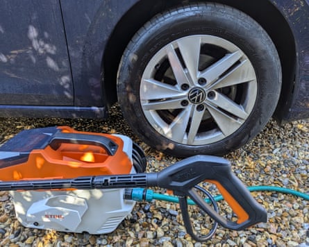 The Stihl Rea 60 Plus cordless pressure washer sitting next to a car tyre that it has just cleaned