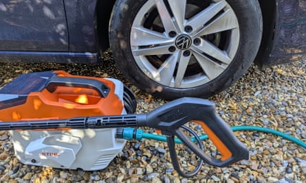 The Stihl Rea 60 Plus cordless pressure washer sitting next to a car tyre that it has just cleaned