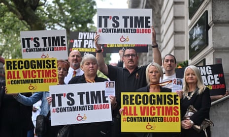 Demonstrators holding placards outside the inquiry into the infected blood scandal in London
