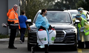 A cleaner dressed in Personal Protective Equipment is seen leaving the Crossroads Hotel in Sydney on Saturday, 11 July 2020.