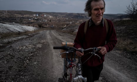 Yuri Ponurenko, 56, walks home after receiving humanitarian aid in the village of Bohorodychne.