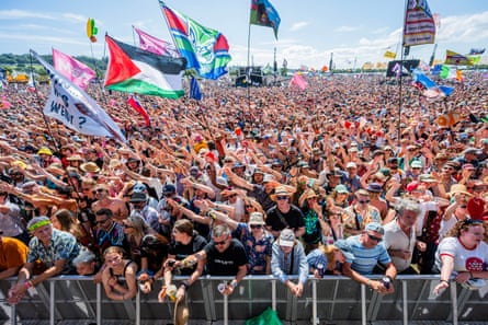 A huge crowd of fans watch a concert at Glastonbury.