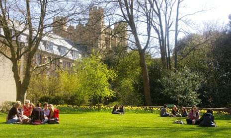 Students relaxing beside one of the university buildings.