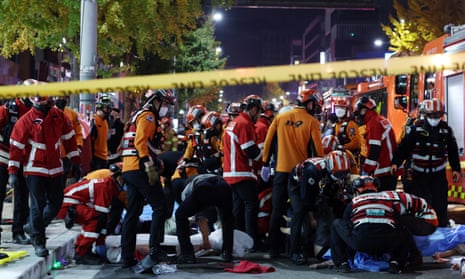 Rescue workers and firefighters at the scene of the crush in Seoul.
