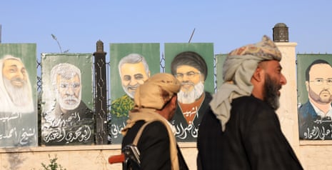 People walk past paintings depicting late military and political figures of Iran-backed Shiite groups of Yemen, Lebanon, Palestine and Iraq on display on a fence at a square in Sana'a, Yemen, 16 June 2025. Yemen's Houthis have targeted Israel with several ballistic missiles over the past 24 hours, in a fresh attack that was coordinated with the Iranian Army and Revolutionary Guard.