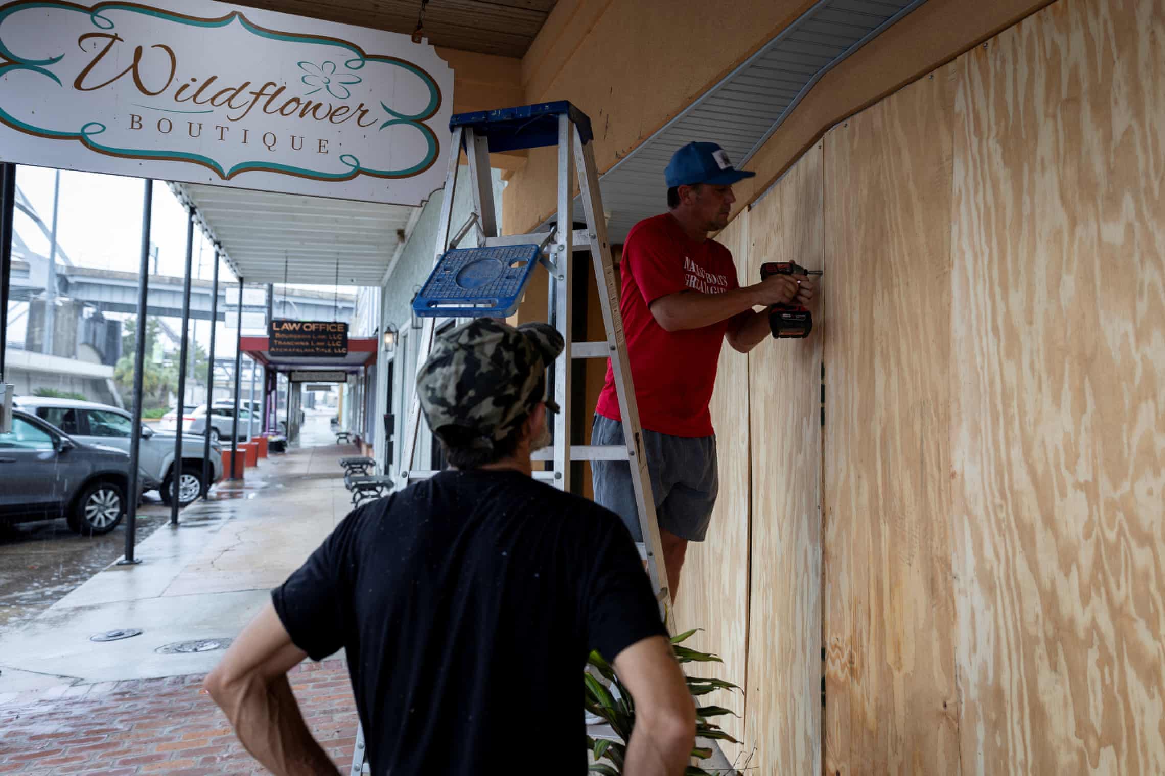 Store windows boarded up before hurricane Francine