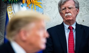 John Bolton listens as Donald Trump speaks in the Oval Office in May last year.