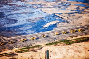 Alberta, Canada: Greed and destruction has turned this into a toxic wasteland. Above, dump trucks queue up to load with tar sands.
