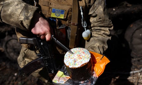Vasilii, 34, who is serving with Ukraine’s 80th brigade near Bakhmut, slices an Easter cake during heavy fighting.