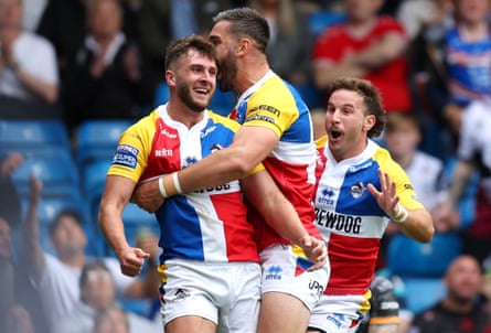 London Broncos players celebrate during a Super League match