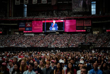 President Donald Trump, seen on a stadium screen, speaks at the memorial for conservative activist Charlie Kirk.