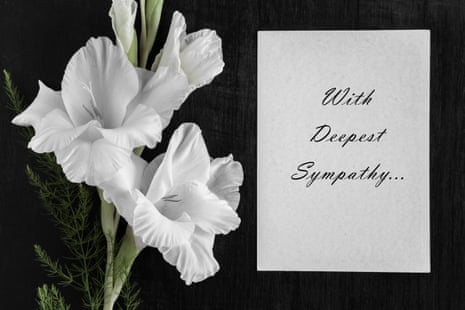 White condolence card with text saying 'with deepest sympathy ... ' and white gladiolus flower on a dark background