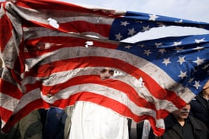 A US flag is defaced after Friday prayers in Tehran