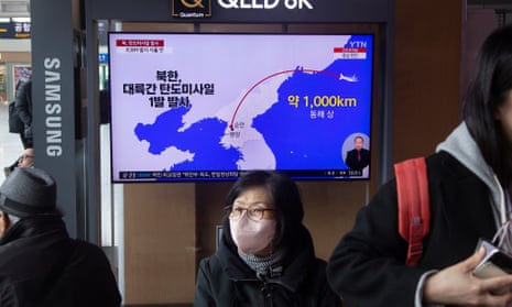 People watch TV news at a station in Seoul, South Korea