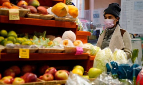 A shopper looks at produce in Washington DC. 