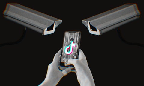 A photo illustration shows two surveillance cameras aimed at a person's smartphone, which is displaying the TikTok logo.