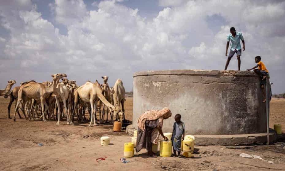 People collect water from a salt water well during a prolonged drought in Mochesa, Kenya. The Red Cross said 1.7 billion people already face food and water shortages.