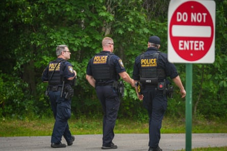 Three law enforcement officers walk outside