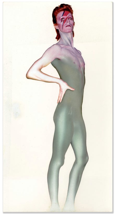 Full-length image of Bowie with lightning bolt on face