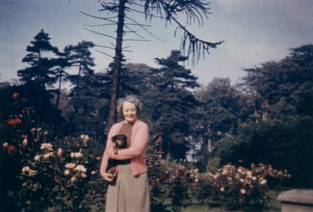 Sylvia Grant-Dalton in the garden, holding one of her pet dachshunds.