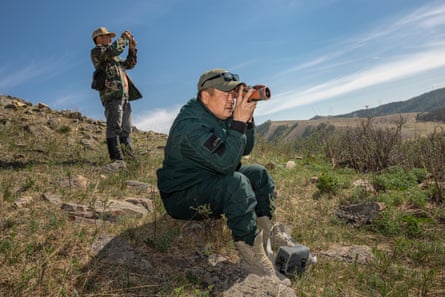Rangers E Munkh-Erdene and T.Delgertuul scan the horizon through monoculars.